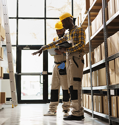 Warehouse managers checking parcels stock using orders checklist